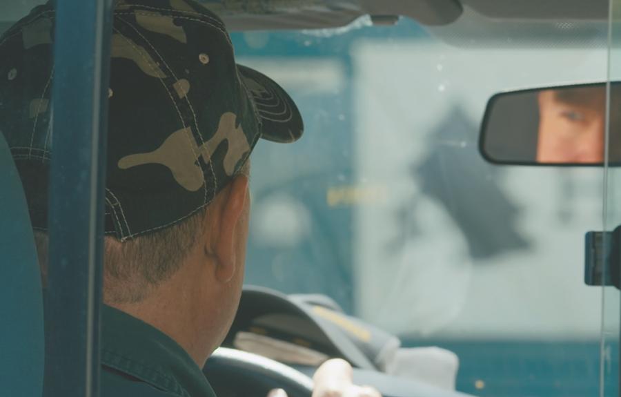 man in hat driving