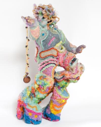 Rainbow sculpture made out of tiny plastic beads.