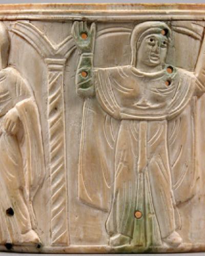 carved bowl with figures raising their arms